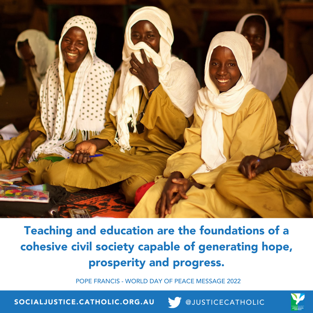 A group of girls look to camera smiling as they sit on the floor of a classroom. There are workbook before them and one holds up her head dress to cover her mouth. A quote from Pope Francis is below the image which reads, "Teaching and education are the foundations of a cohesive civil society capable of generating hope, prosperity and progress."