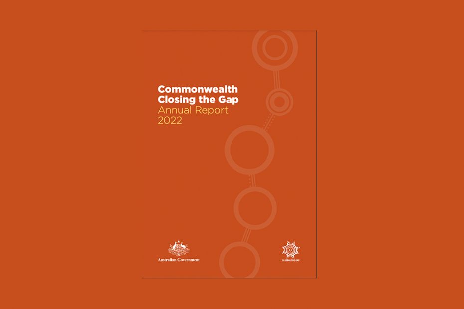 A picture of the Closing the Gap report which has a red dust coloured background and a simple dot painting on the right hand side of several concentric circles linked together by a path of white dots.