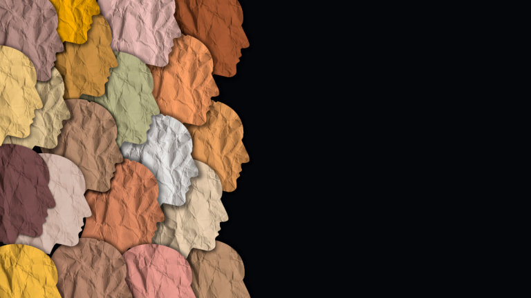 Multicultural felt cutouts of people on a black background