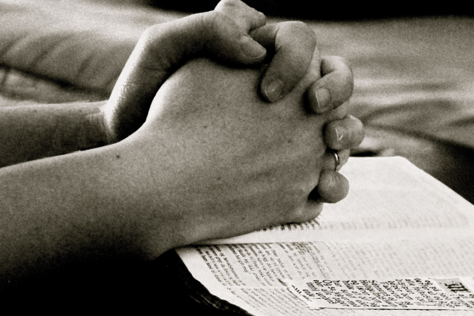 Black and White photo of hands clasped in prayer