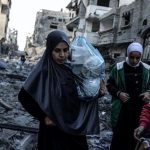 Three women among rubble in Gaza
