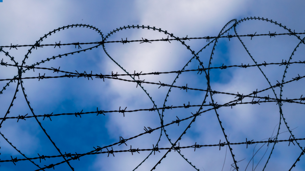 Barbed Wire in the shape of a heart, with blue sky in the background