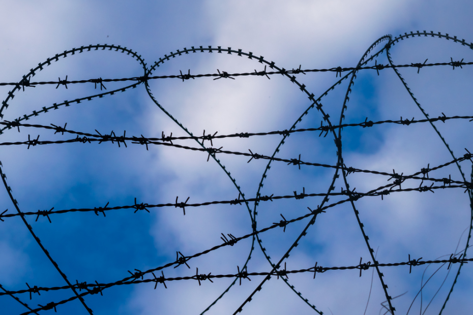 Barbed Wire in the shape of a heart, with blue sky in the background