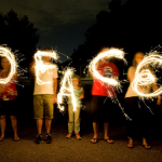 People forming the word Peace together