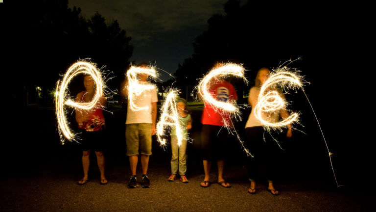 People forming the word Peace together